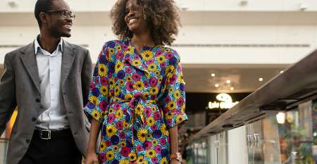 Smartly dressed smiling couple in shopping mall