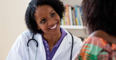 Smiling female doctor with patient