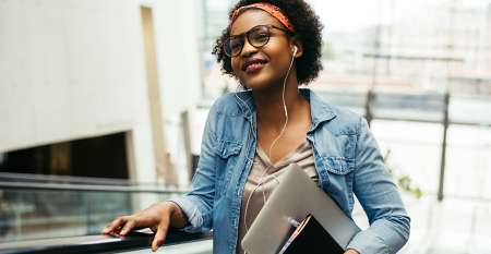 Young woman on escalator listening to music
