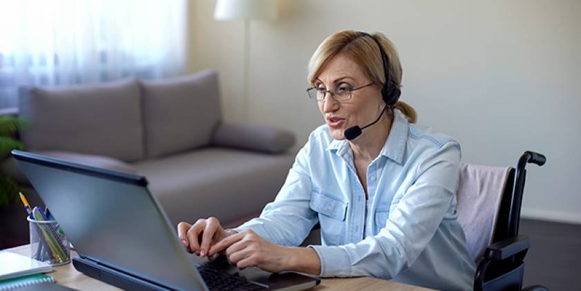 Woman wearing headphones calling on PC